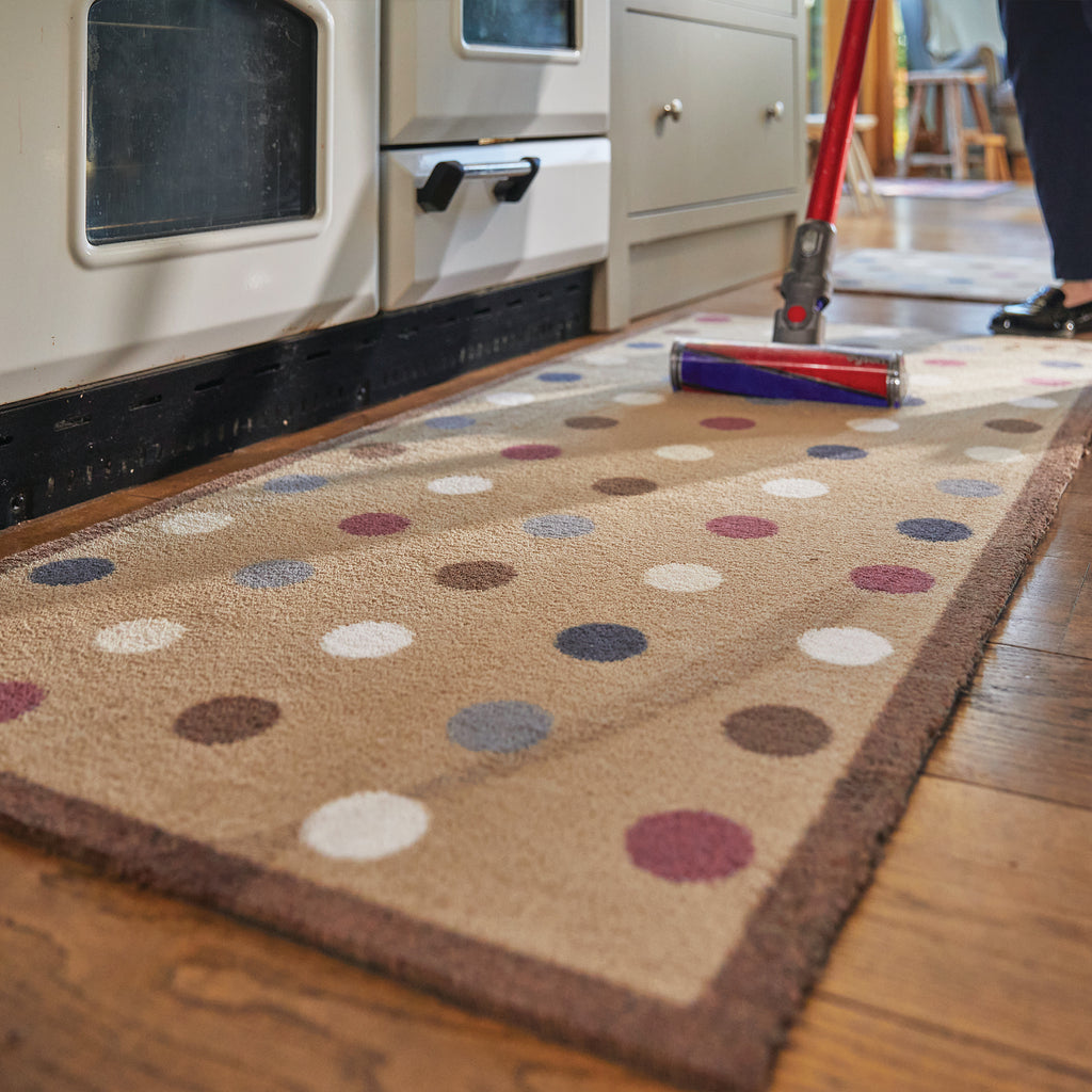 Spot 10 Brown Washable Runner in Brown- a 100% recycled cotton runner featuring an array of darker-toned spots in blue and red, accented with a few white and cream spots.