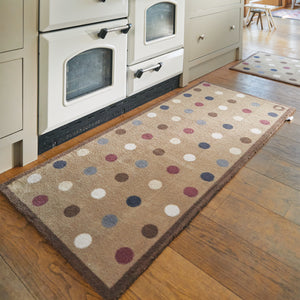 Spot 10 Brown Washable Runner in Brown- a 100% recycled cotton runner featuring an array of darker-toned spots in blue and red, accented with a few white and cream spots.