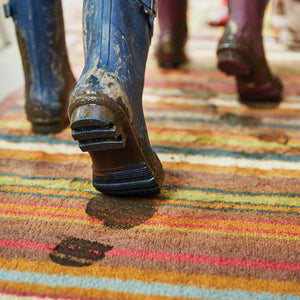 Stripe 70 Red/Blue Washable Runner- a 100% recycled cotton runner featuring vertical stripes in brown, green, red, orange, charcoal, and white.