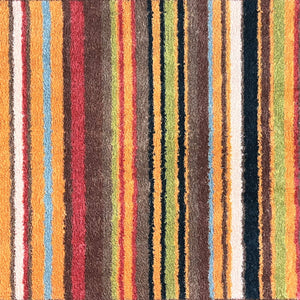 Stripe 70 Red/Blue Washable Runner- a 100% recycled cotton runner featuring vertical stripes in brown, green, red, orange, charcoal, and white.