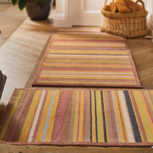 Stripe 70 Red/Blue Washable Runner- a 100% recycled cotton runner featuring vertical stripes in brown, green, red, orange, charcoal, and white.