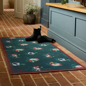 Swimming Ducks Teal Washable Runner- a 100% recycled cotton runner featuring multiple ducks swimming and creating ripples in the water.