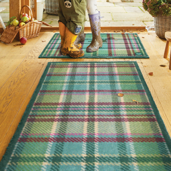Tartan Green Washable Runner in Green- a 100% recycled cotton runner featuring a traditional tartan design in shades of green with hints of pink, burgundy, and beige.