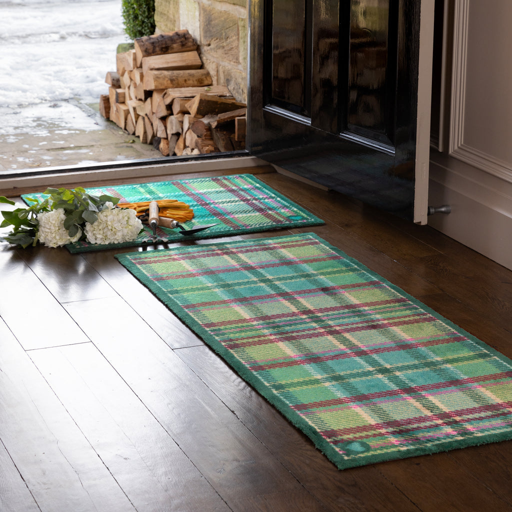 Tartan Green Washable Runner in Green- a 100% recycled cotton runner featuring a traditional tartan design in shades of green with hints of pink, burgundy, and beige.