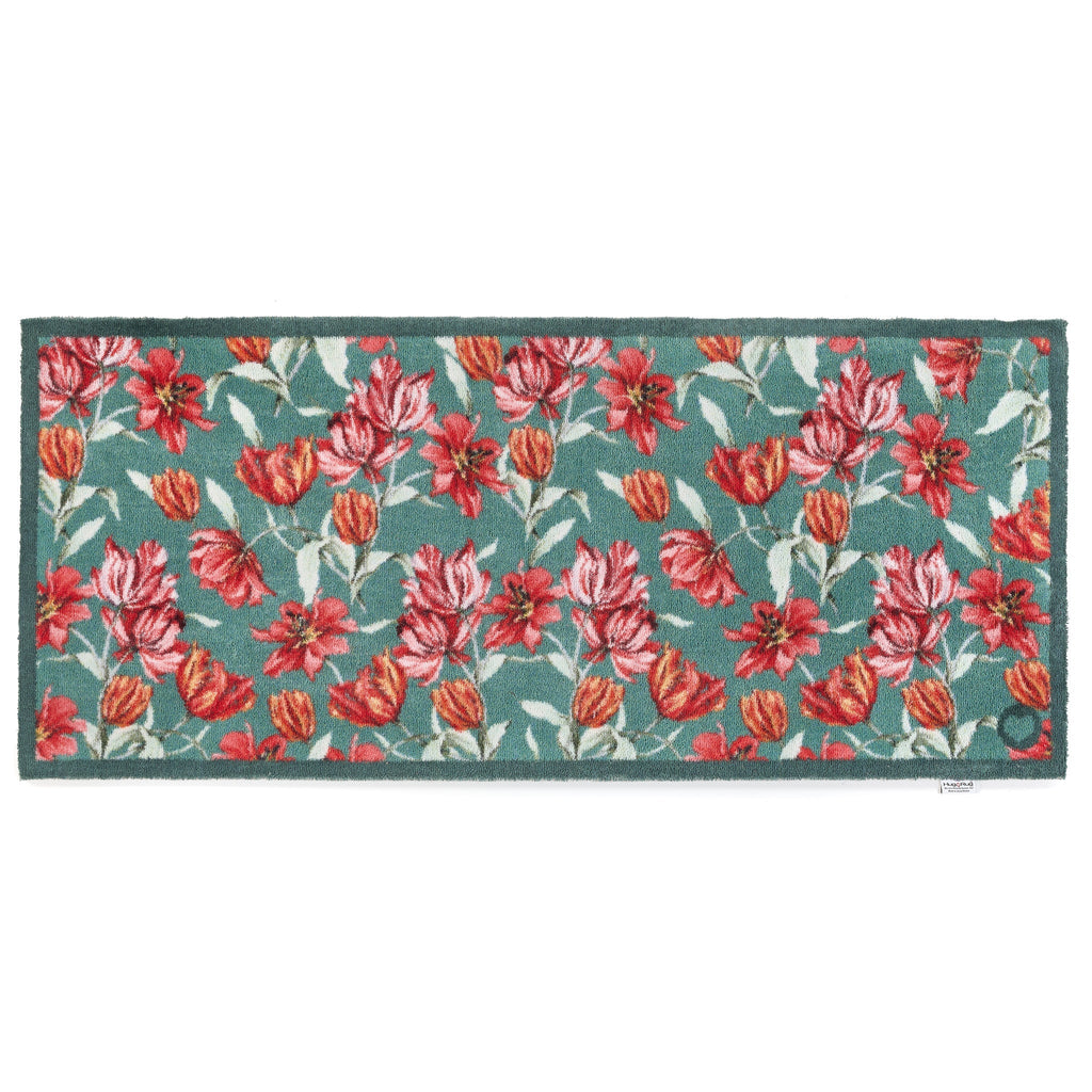 Tumbling Tulips Washable Runner- a 100% recycled cotton runner featuring tulips in rich reds, pinks and oranges, scattered across a soft teal backdrop.