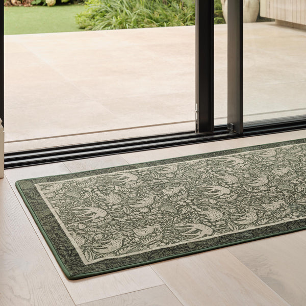 Whimsical Woodland Eco-Washable Runner – a green eco-washable runner featuring white woodland animals and white florals.