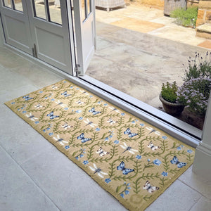 Wild Meadow Beige Green Washable Runner- a 100% recycled cotton runner featuring intertwining vines with a collection of hand-painted butterflies, dragonflies, and blue flowers.