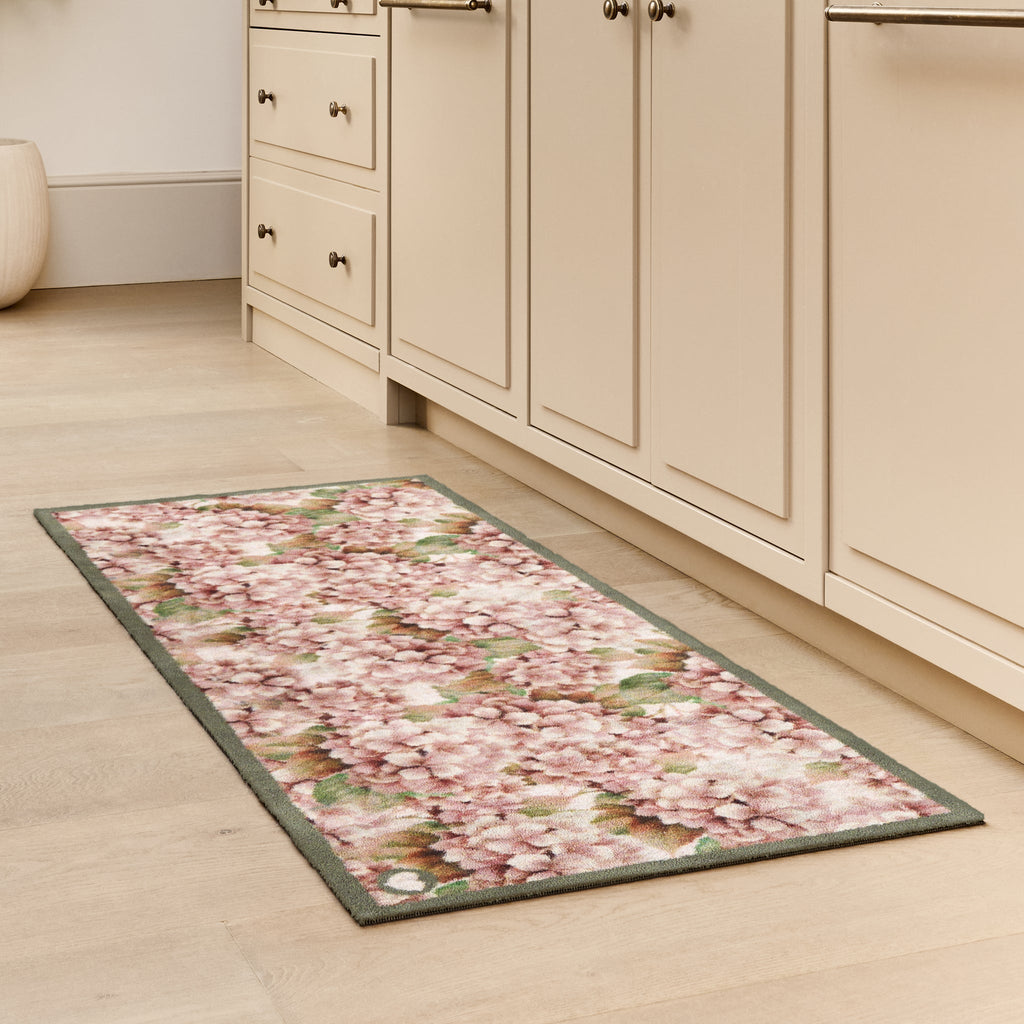 Wild Hydrangea Washable Runner- a 100% recycled cotton runner featuring hydrangea blooms in rust and soft pinks, accented with green and olive leaves.