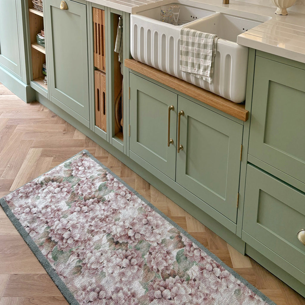 Wild Hydrangea Washable Runner- a 100% recycled cotton runner featuring hydrangea blooms in rust and soft pinks, accented with green and olive leaves.