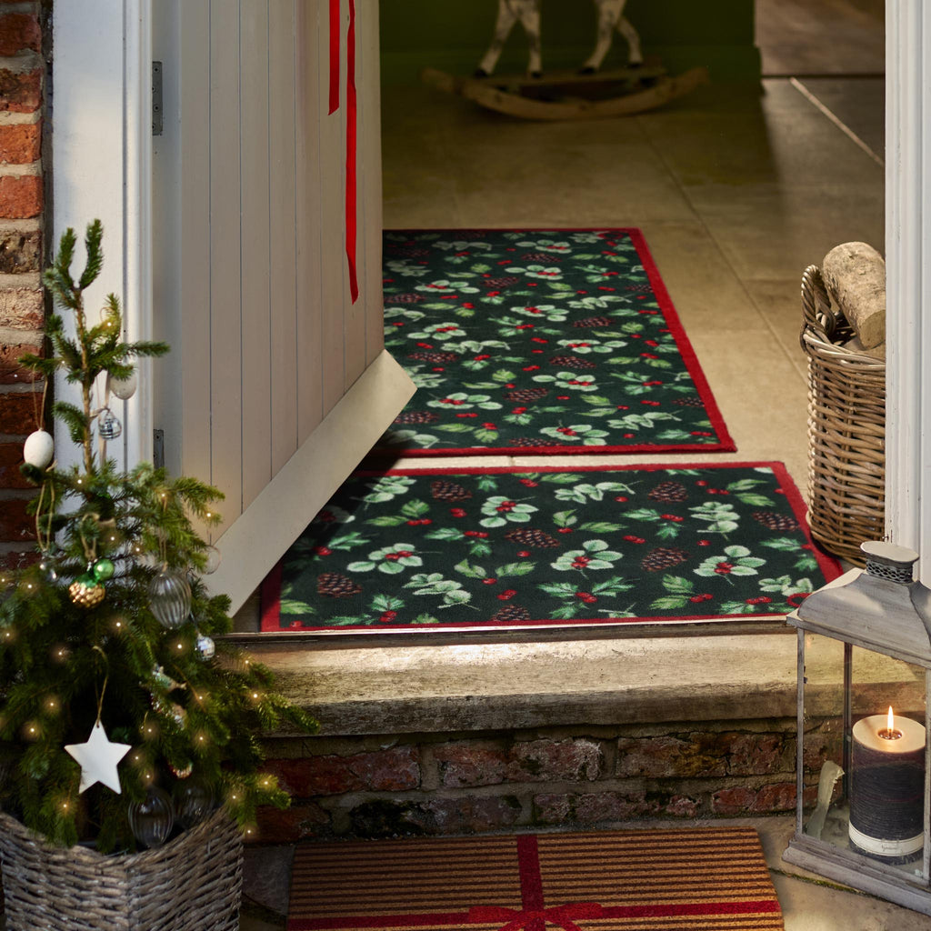 Winter Berries Washable Runner in green- a 100% recycled cotton runner featuring clusters of holly leaves, bright red berries, pinecones, and soft eucalyptus accents.