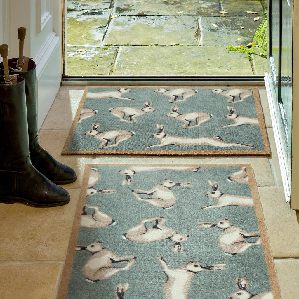 hares design on a washable mat in a doorway