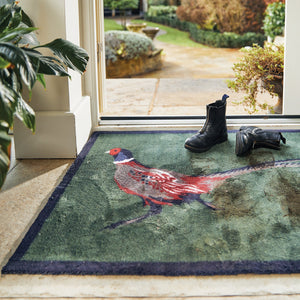 Pheasant green design on a washable mat in a doorway