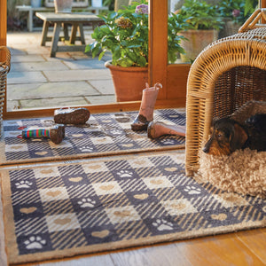 Lifestyle image of a dog lying on a beige Hug Rug Pet Check 1 washable doormat and washable runner