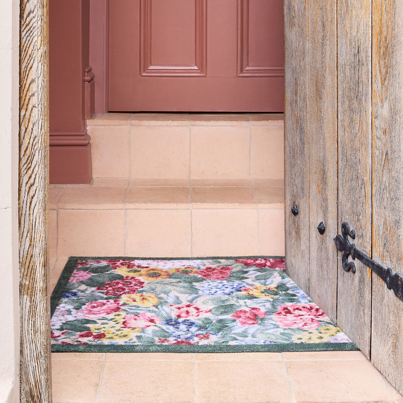 Antique Hydrangea & Rose Chintz Washable Doormat with a floral design, styled on tiled flooring.