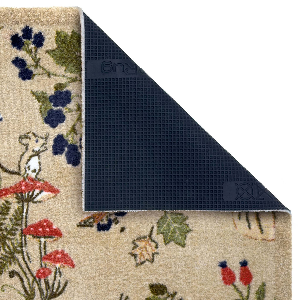 A close-up of a patterned doormat with a corner folded back to show the dark textured underside. The top surface features a beige base with a whimsical woodland print including a mouse, red mushrooms, blue berries, and green leaves.