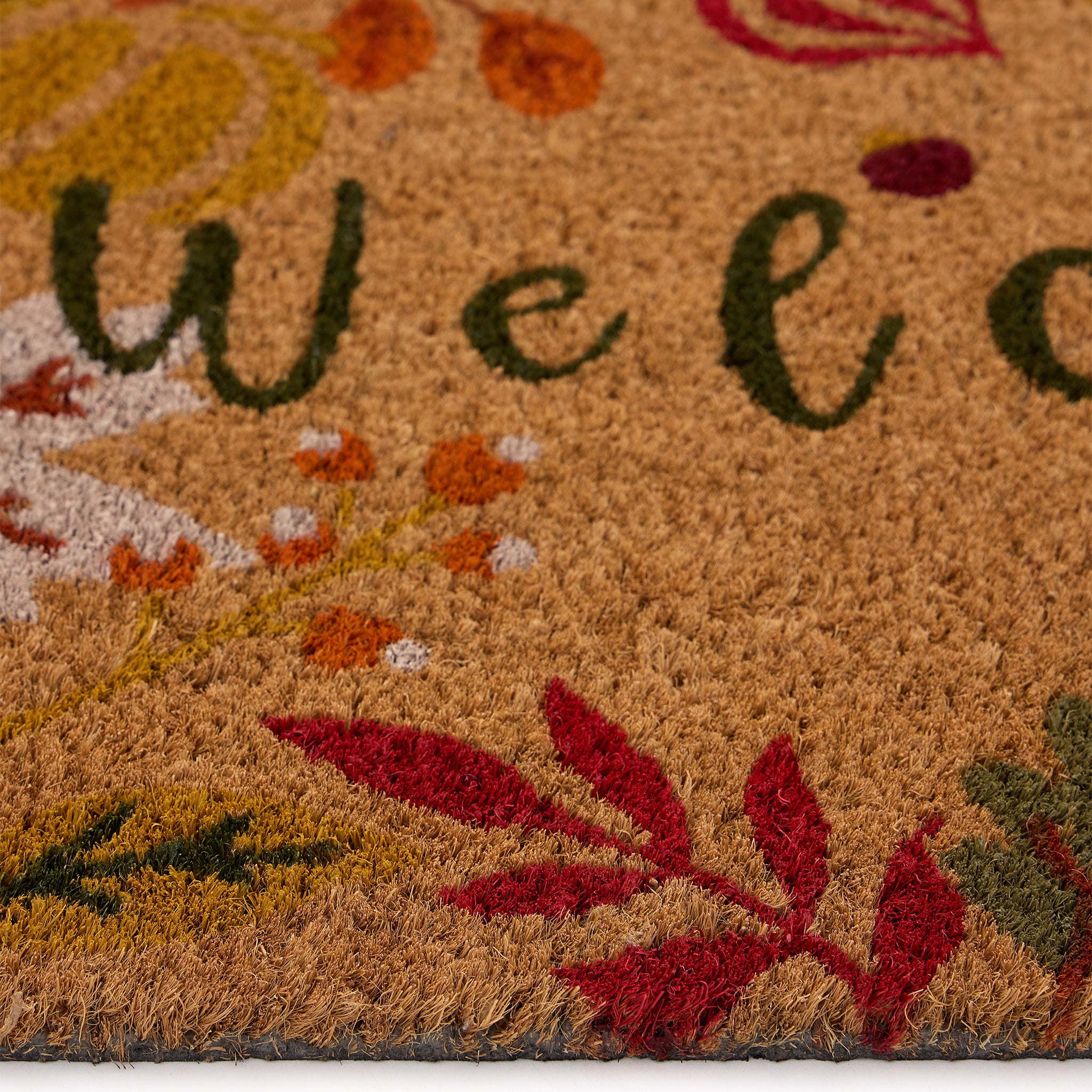 Discover the Autumnal Welcome Coir Doormat- a coir doormat featuring leaves, berries, pumpkins and mushrooms with a graphic font. 