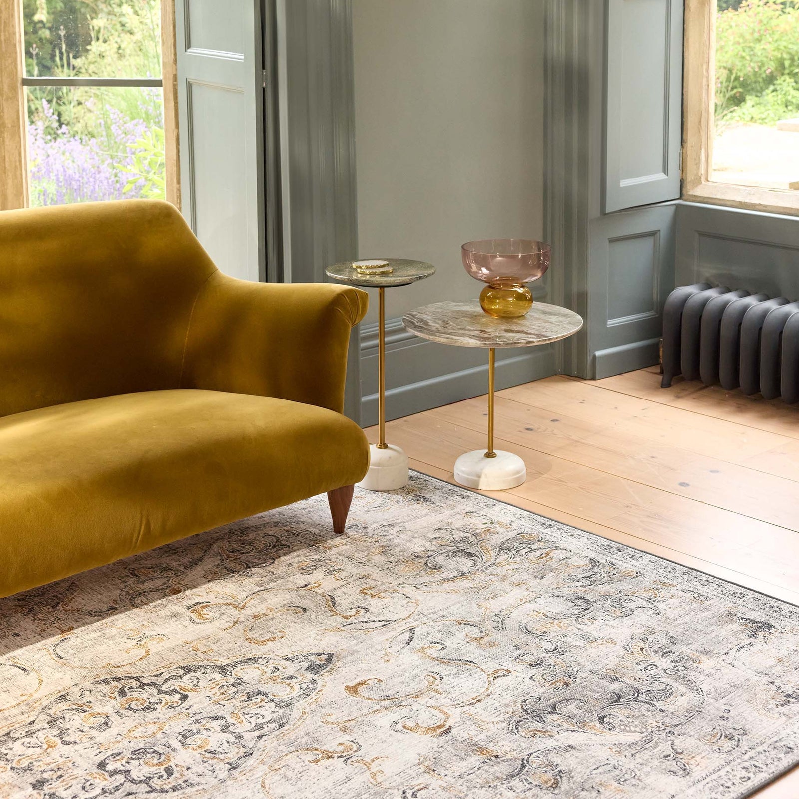 Baroque Eco‑Washable Rug with a textured ornate pattern, styled in a living room. 