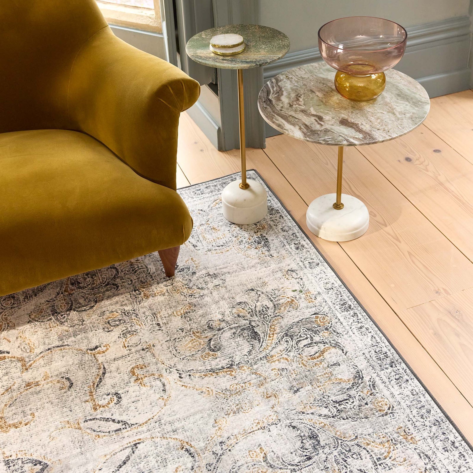 Baroque Eco‑Washable Rug with a textured ornate pattern, styled in a living room. 