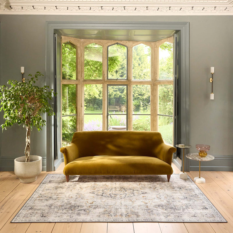 Baroque Eco‑Washable Rug with a textured ornate pattern, styled in a living room. 
