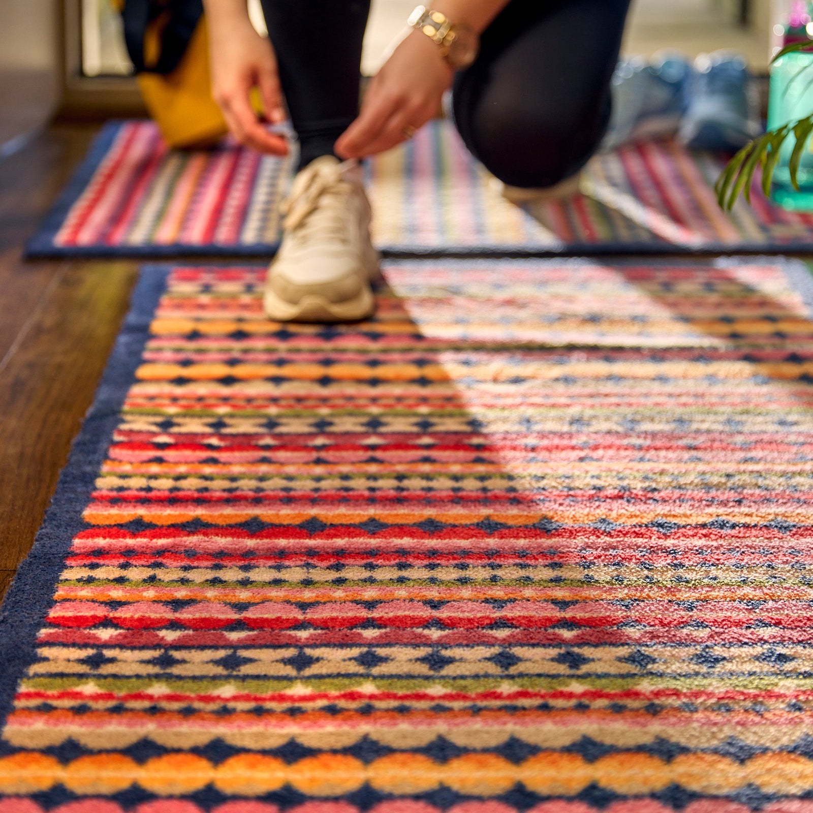 Beady Stripe Charity Runner- a 100% recycled cotton runner featuring multi-coloured stripe pattern in navy, red, pink, orange, green, white and beige.