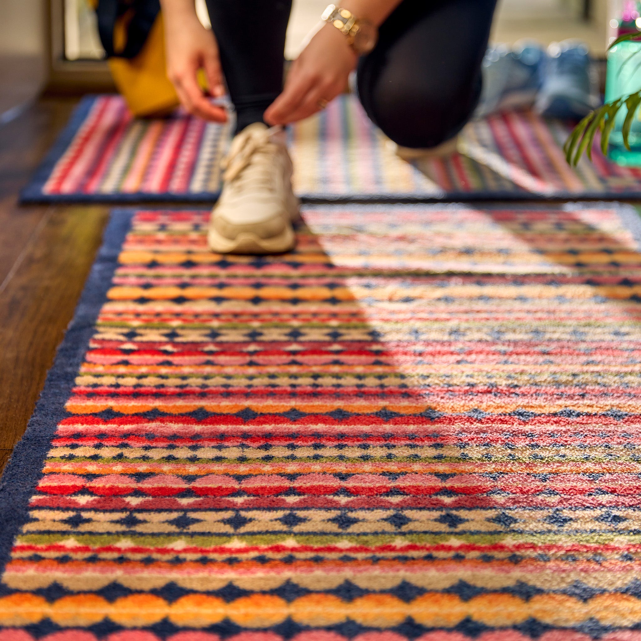 Beady Stripe Charity Runner- a 100% recycled cotton runner featuring multi-coloured stripe pattern in navy, red, pink, orange, green, white and beige.
