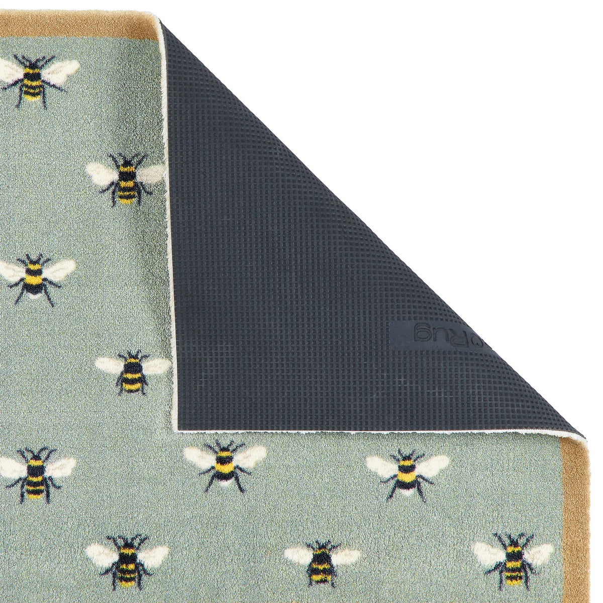 A close-up of a doormat corner with the top-left section folded back to show the backing. The visible top surface has a pale sage green base with a repeating pattern of bumblebees in black, yellow, and white.
