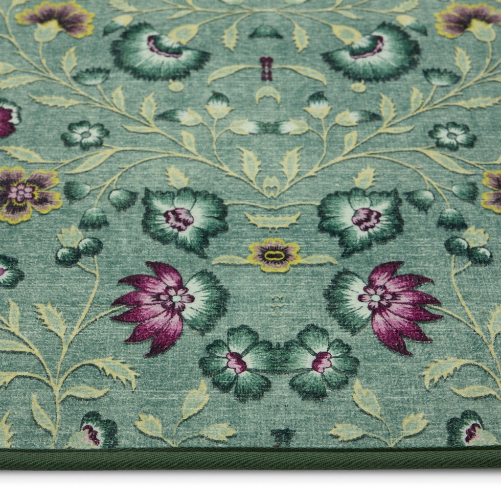 Blossoming Vines Eco-Washable Rug- a green eco-washable rug featuring colourful florals and green leaves. 