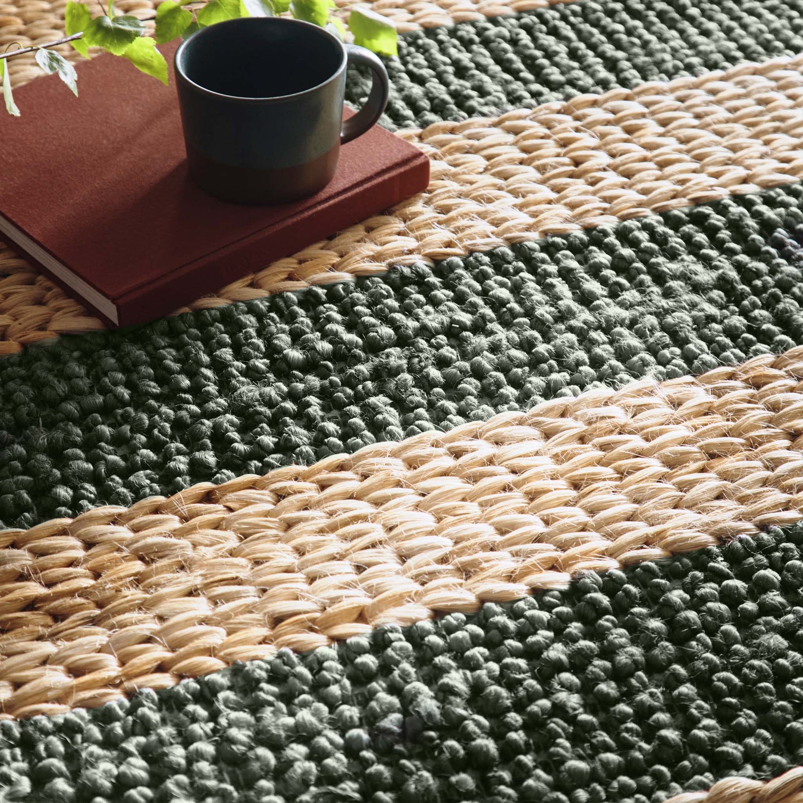 Close-up of Bondi Jute Stripe Natural/Bottle Green Rug with a green stripe design.