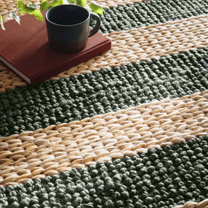 Close-up of Bondi Jute Stripe Natural/Bottle Green Rug with a green stripe design.