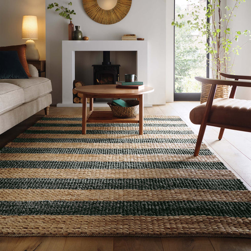 Bondi Jute Stripe Natural/Bottle Green Rug with a green stripe design, styled in a living room.