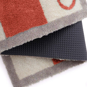 Bone Stripe Rust- 100% recycled cotton doormat featuring a striped pattern with a bone in the centre.
