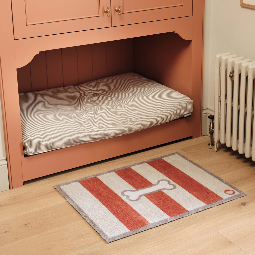 Bone Stripe Rust- 100% recycled cotton doormat featuring a striped pattern with a bone in the centre.