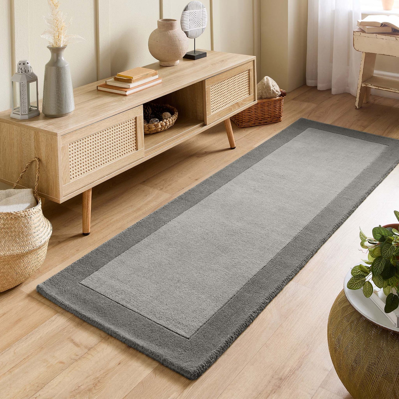 Borders Grey 100% wool runner with a two-tone border design, styled in a small room.