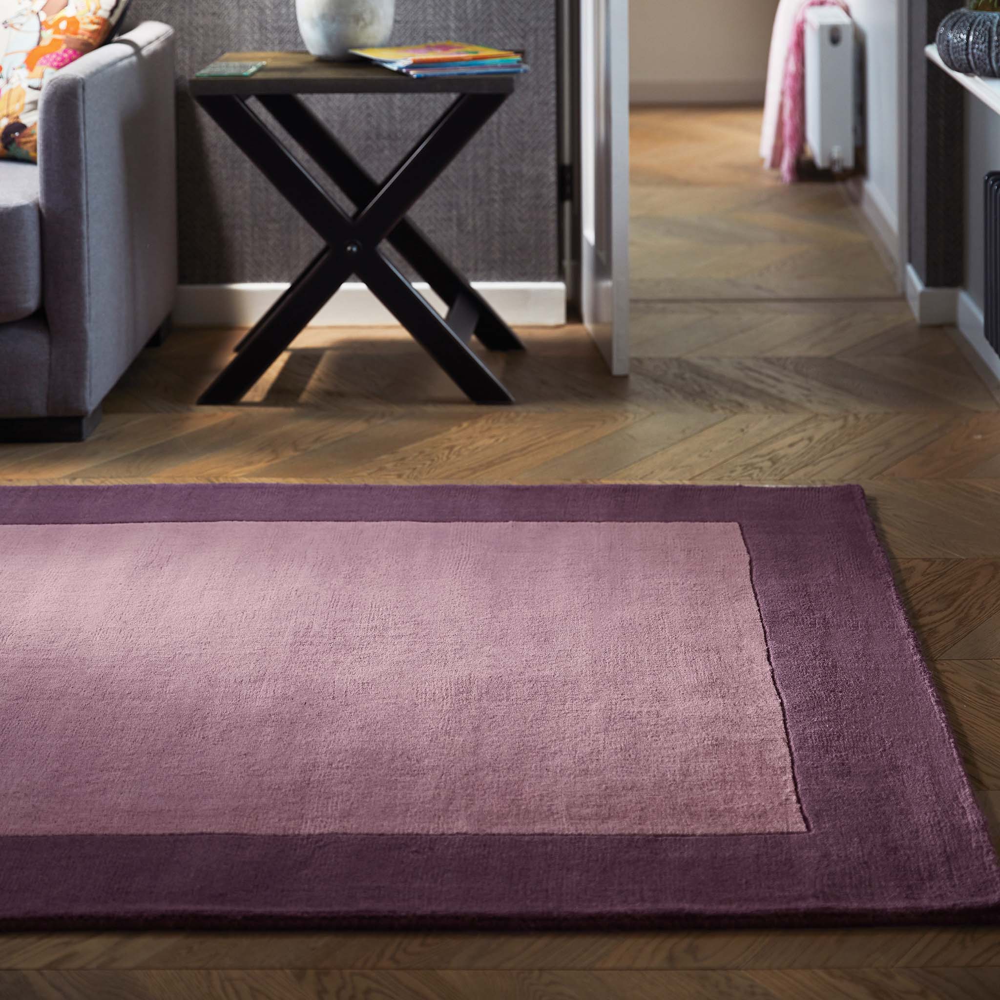 Borders Mauve Pink Purple 100% wool rug with a two-tone border design, styled in a living room.