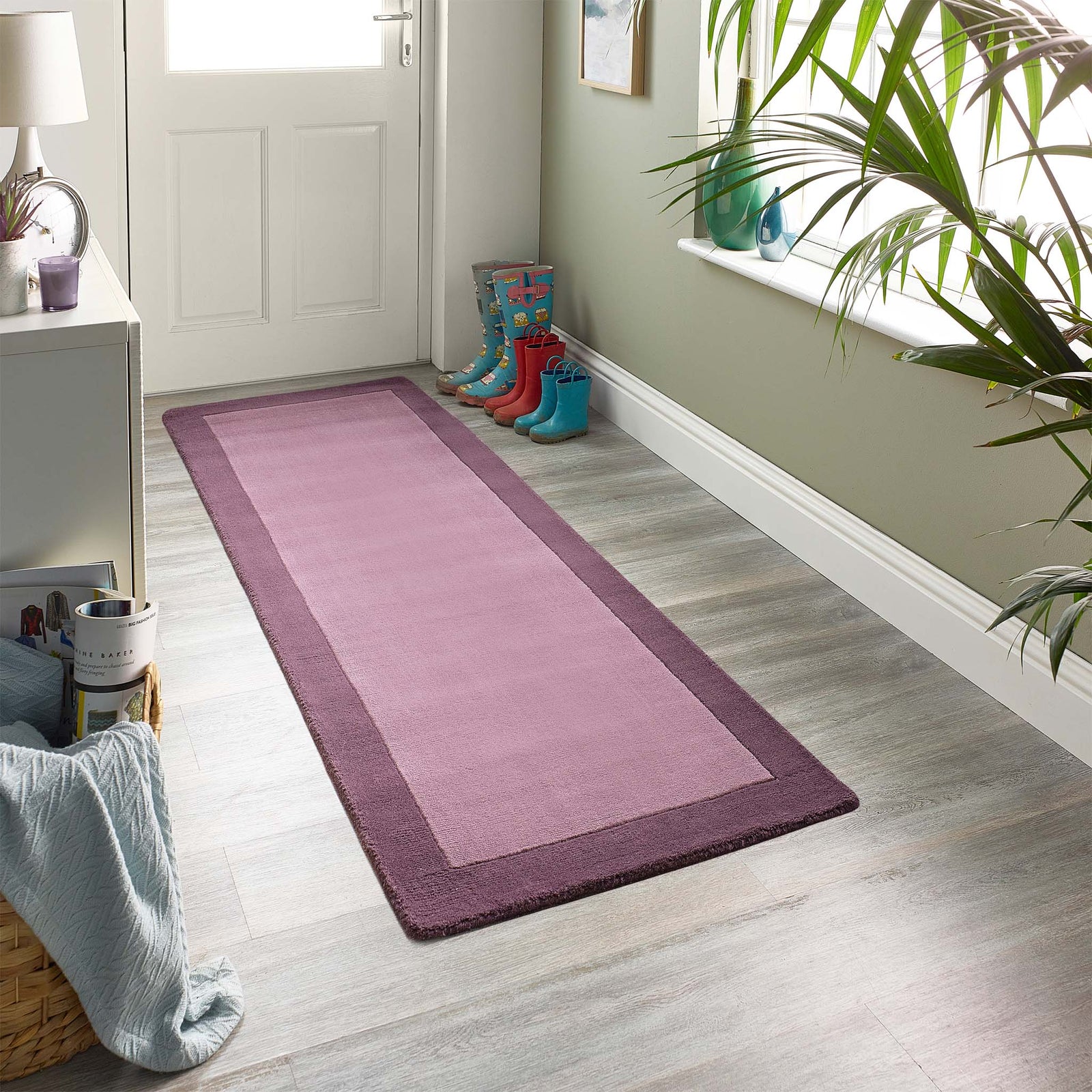 Borders Mauve Purple Pink 100% wool runner with a two-tone border design, styled in a entryway.