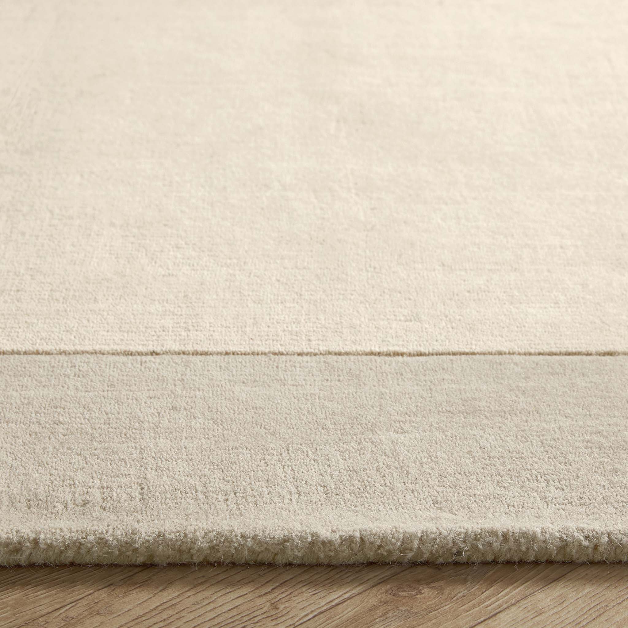 Border Nautral Rug - a 100% wool rug featuring a darker natural border. 