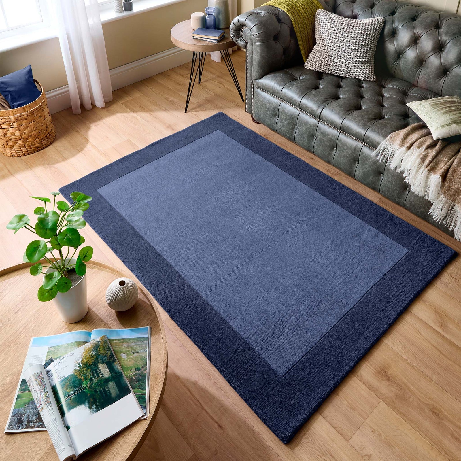 Borders Navy Blue 100% wool rug with a two-tone border design, styled in a living room.