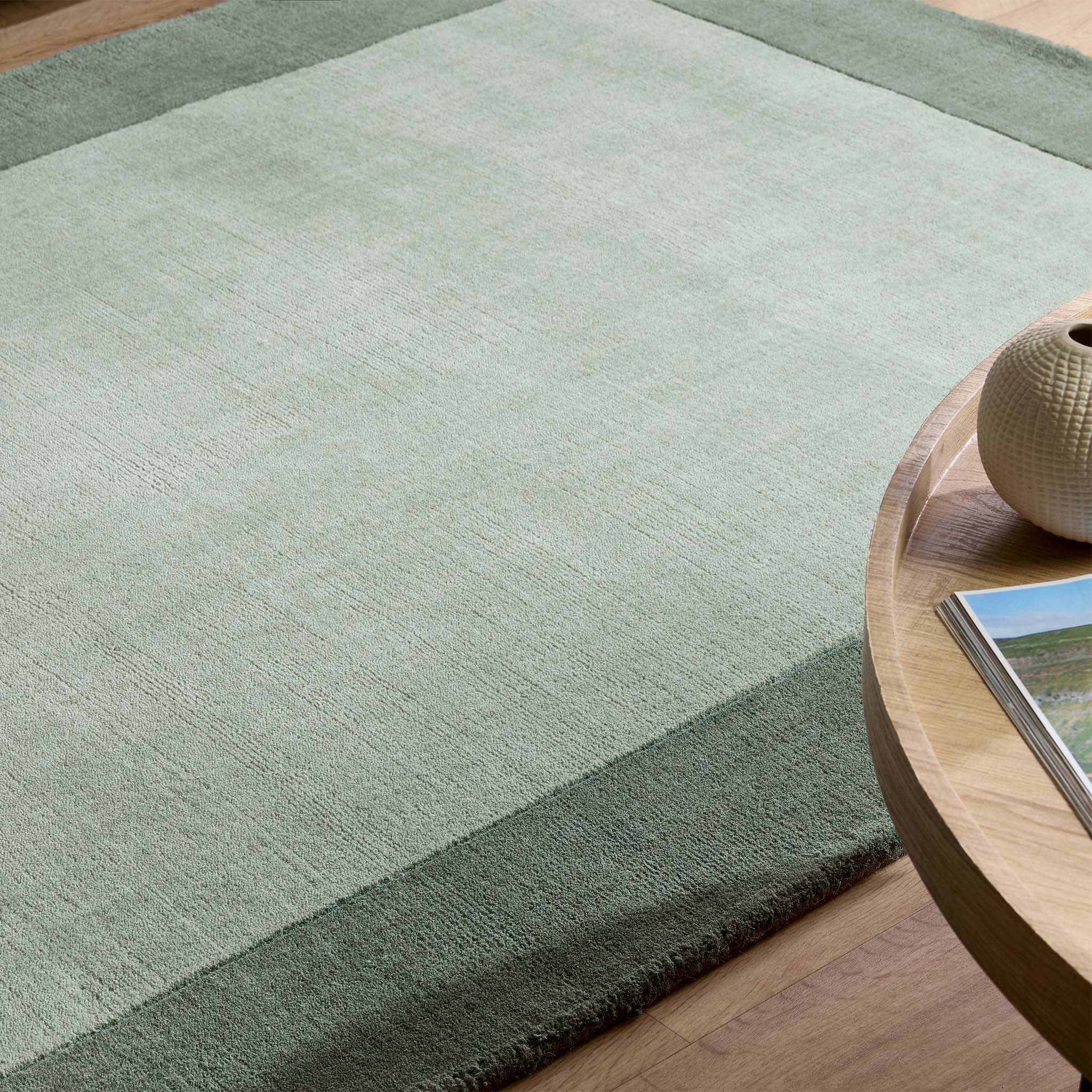 Borders Sage Green Rug - 100% wool rug in light green with a darker green border. 