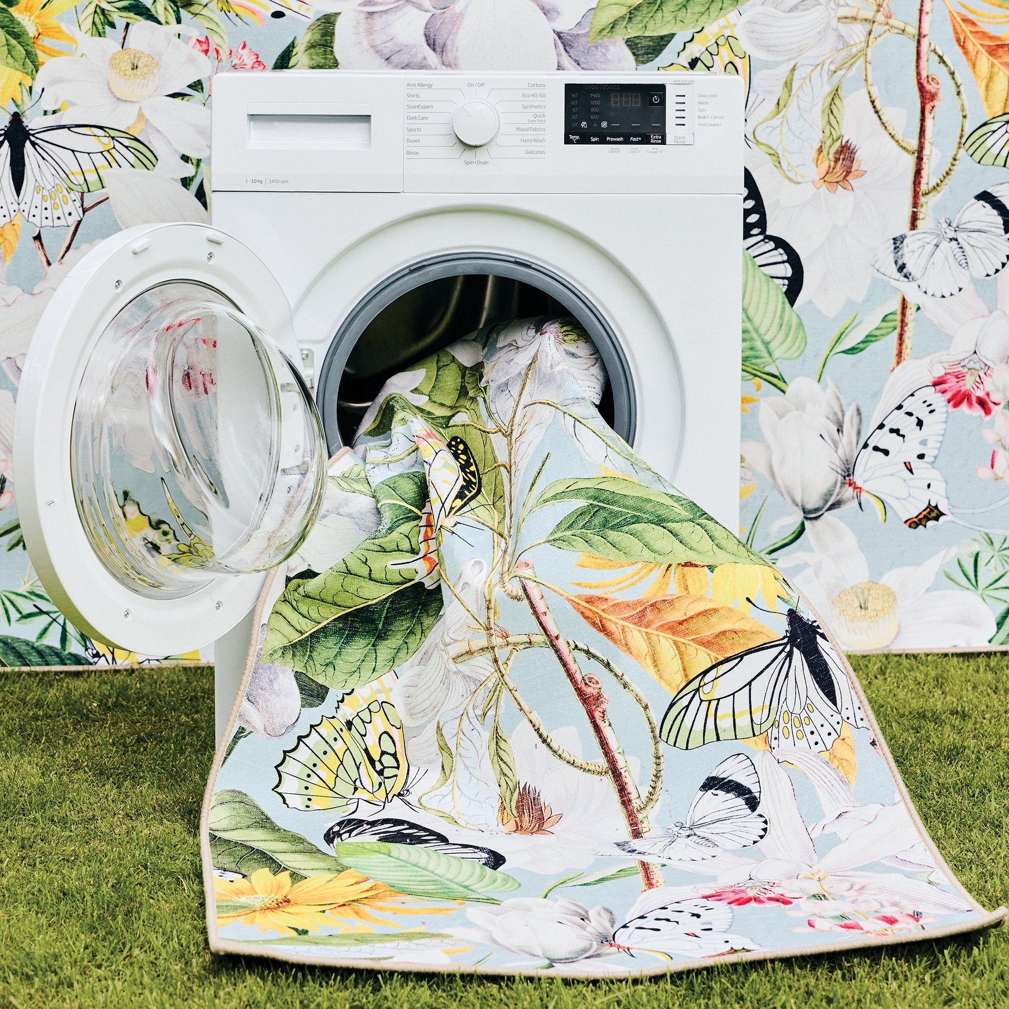 Butterfly Blooms Eco Washable Rug made from 100% recycled materials, featuring butterflies and oversized blooms.