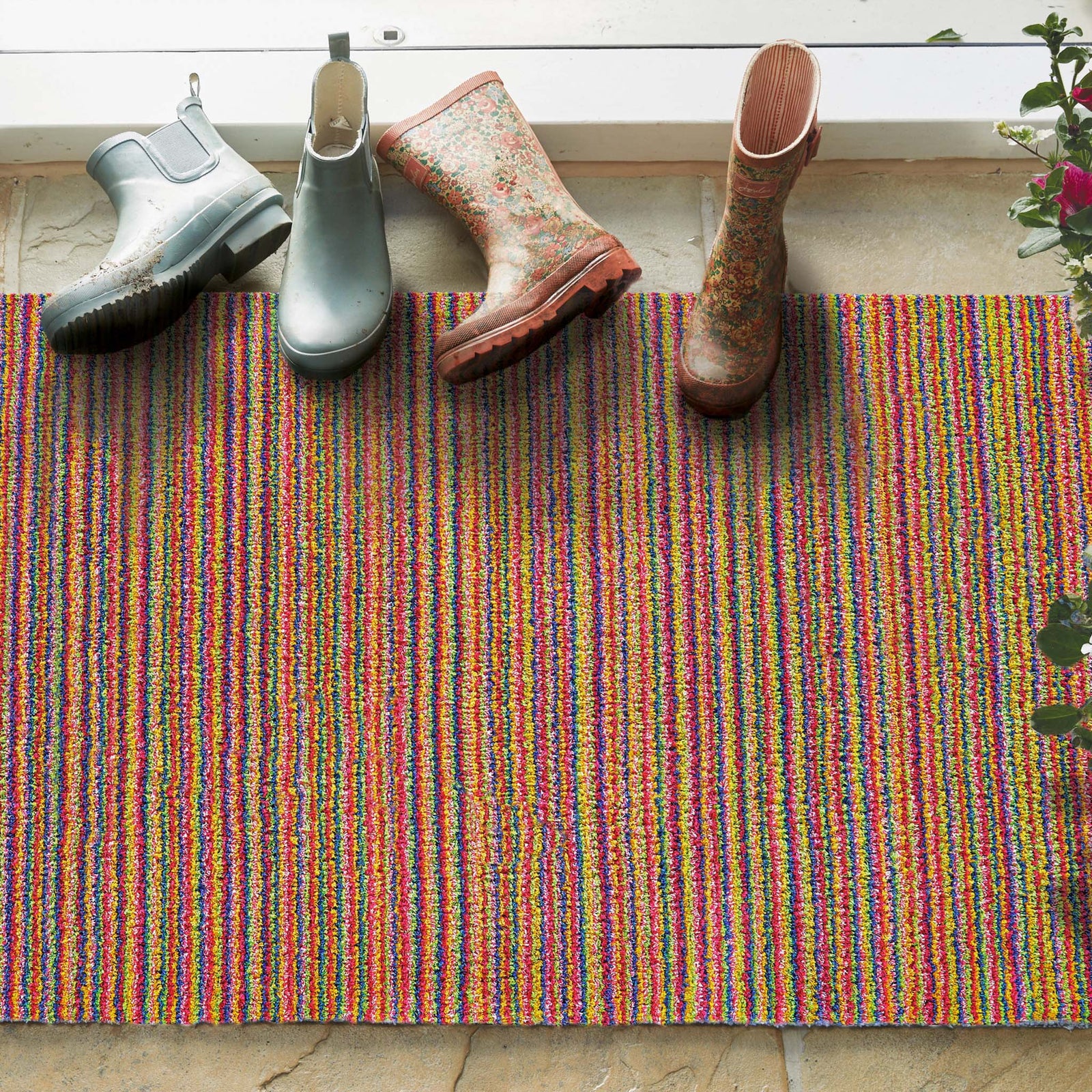 Candy Bright Doormat - a 100% recycled material doormat featuring a colourful  striped pattern. 
