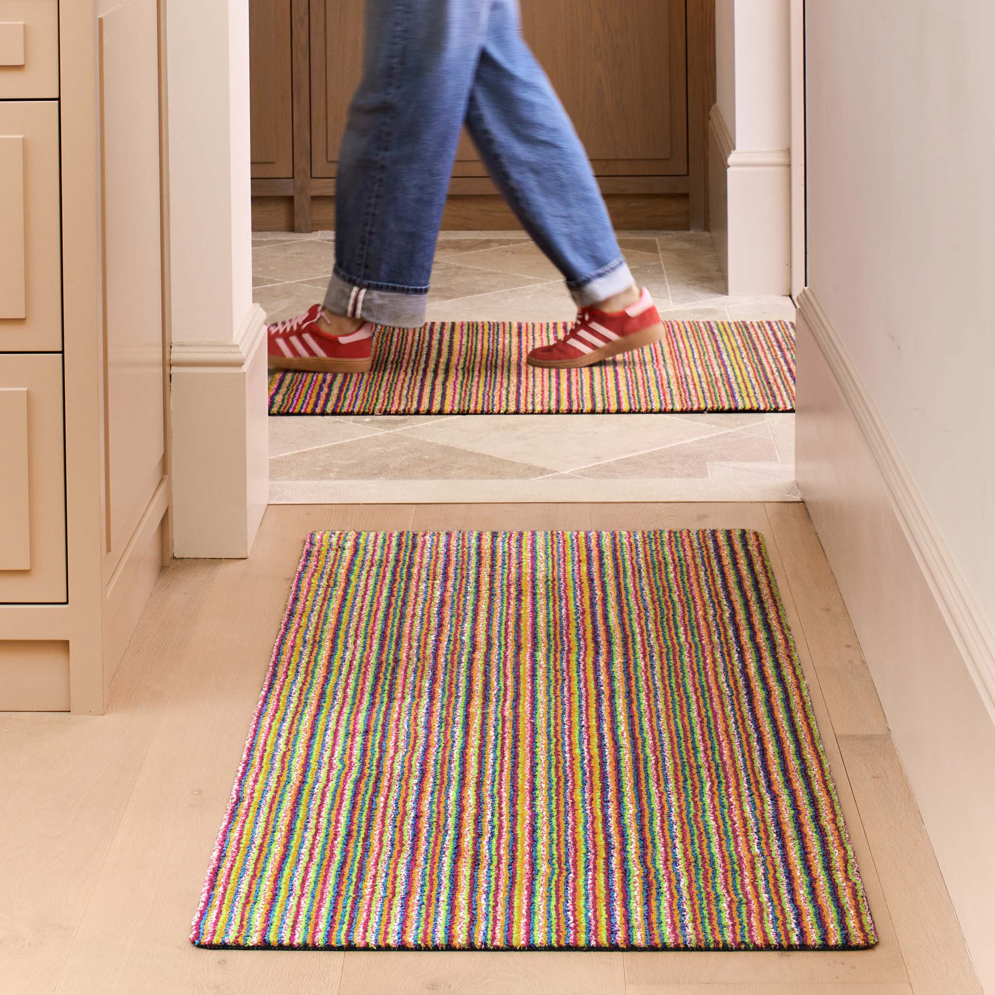 Candy Bright Multi Washable Runner with a striped design, styled in a entryway.