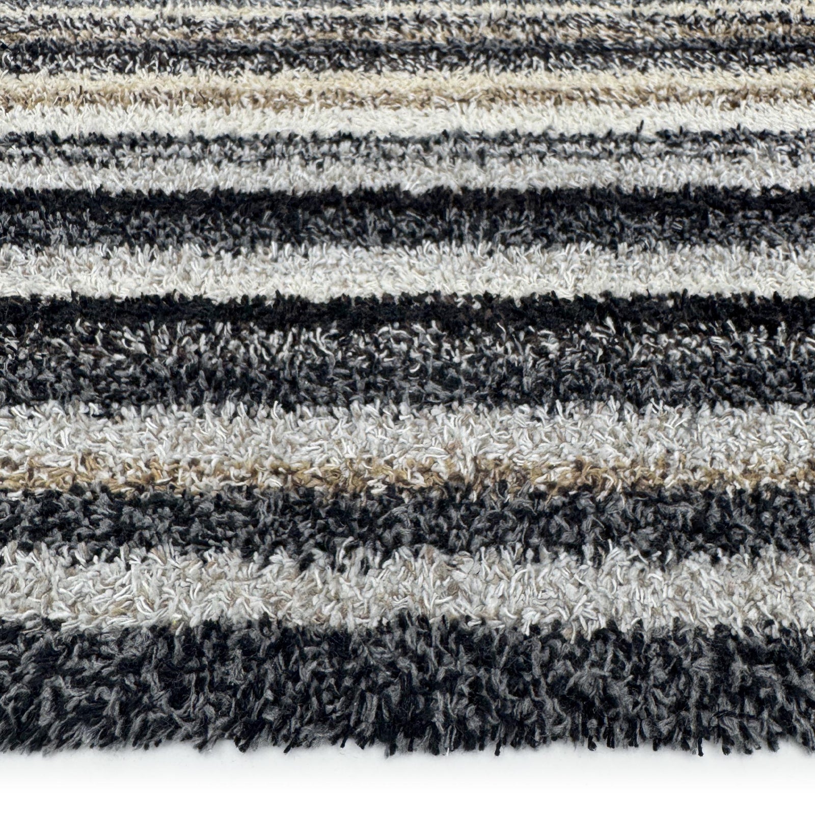 Candy Monochrome Washable Runner- a 100% recycled material runner featuring a subtle striped pattern in beige, grey, brown, black, and white. 