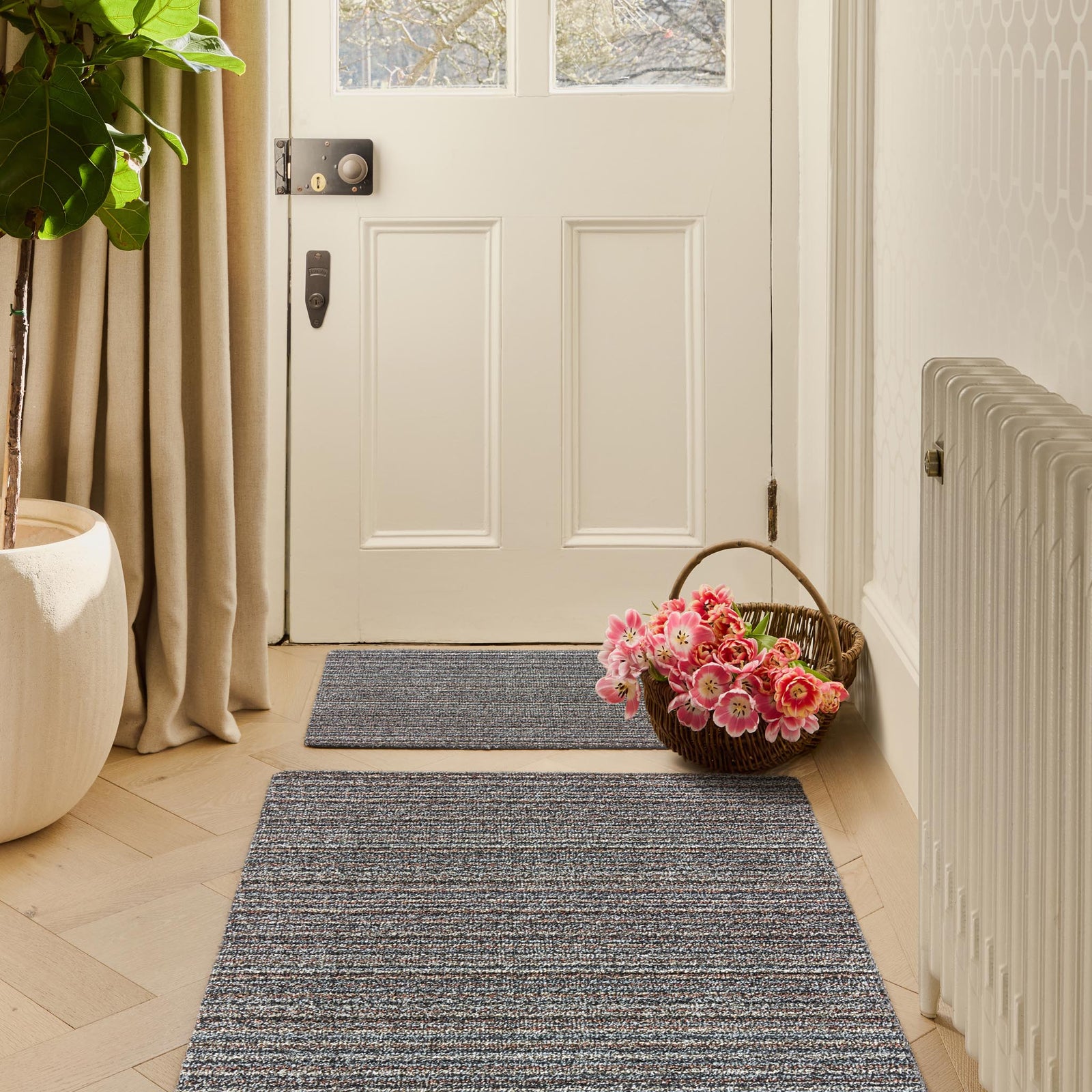 Candy Rocks Stripe Grey Doormat with a stripe design, styled in a entryway. 