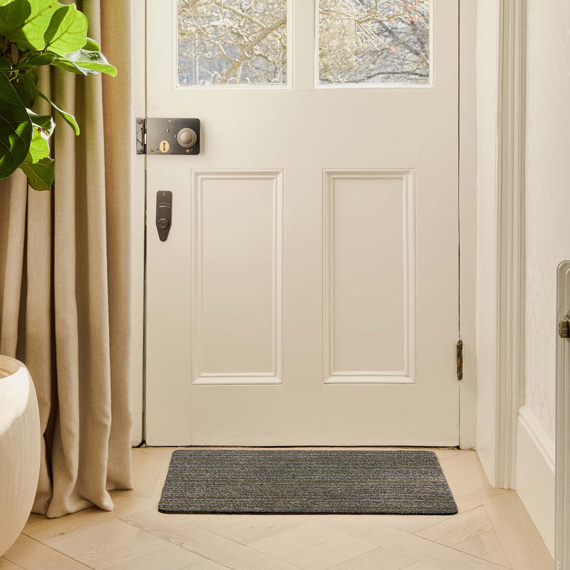 Candy Sage Green Cotton Doormat with a striped design, styled in a doorway.