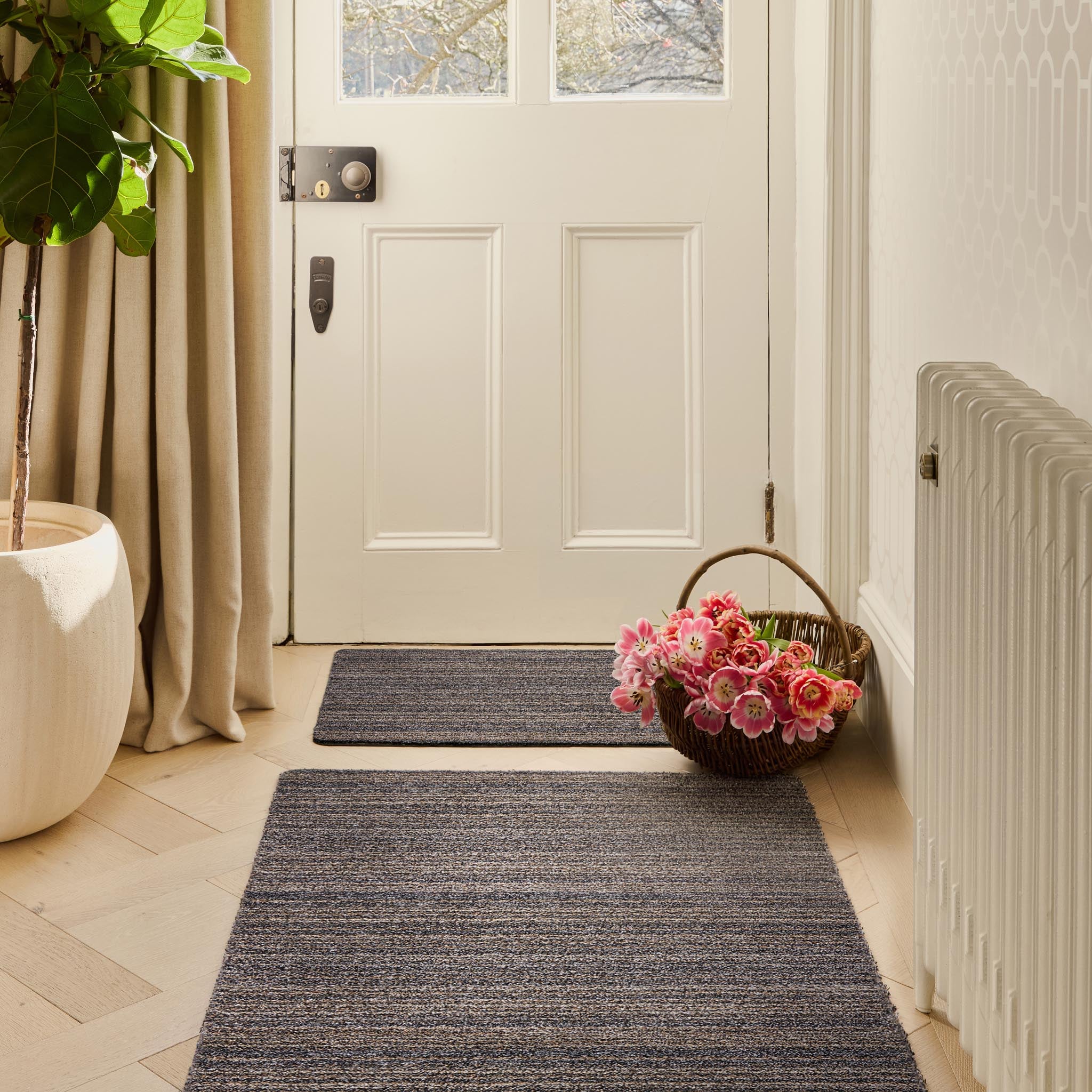Candy Slate Doormat and Runner in a grey stripe pattern, styled in front of an entryway.