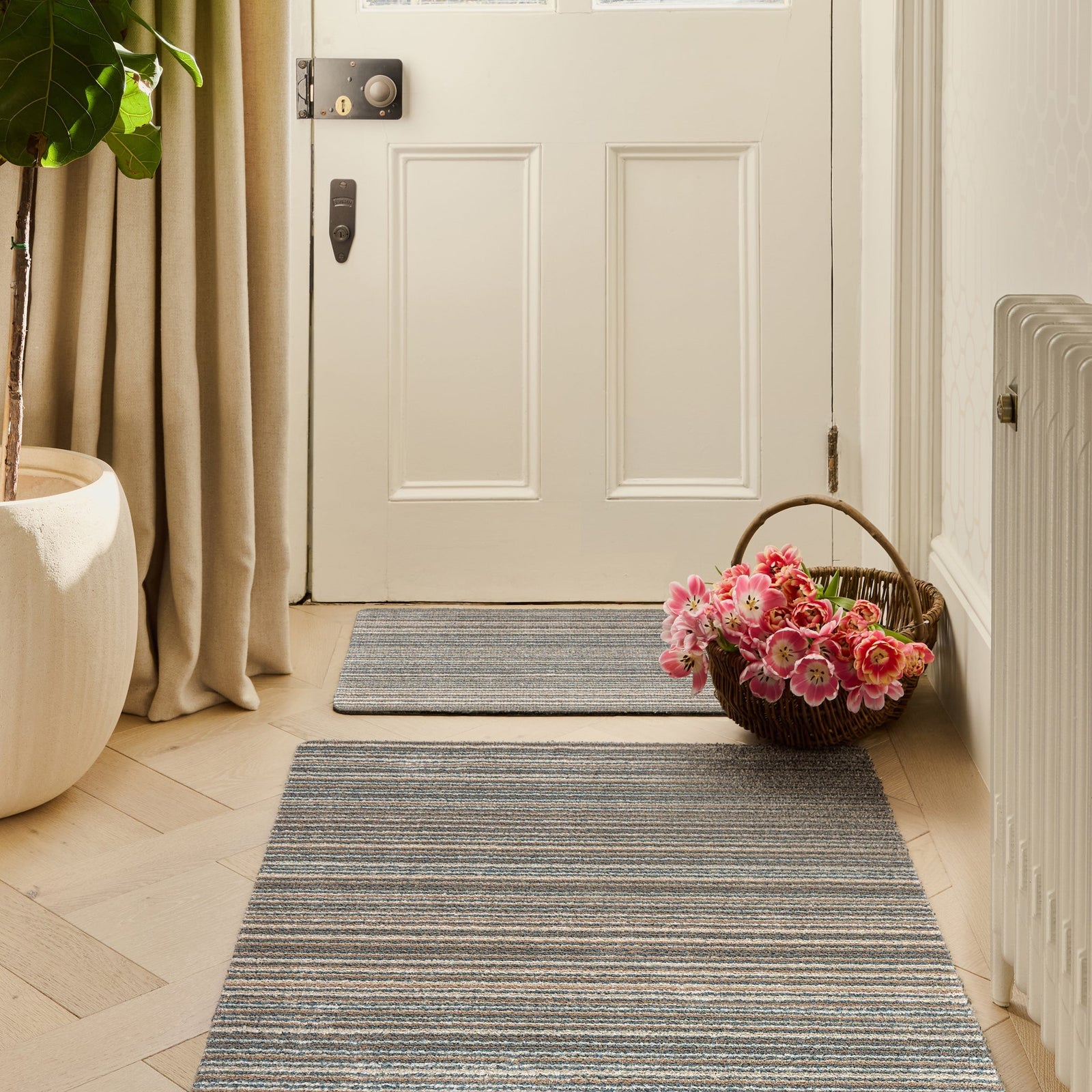 Candy Sand Stripe Washable Doormat- a recycled material doormat with a fleck design in the shades of teal, beige, brown, white, and light grey. 