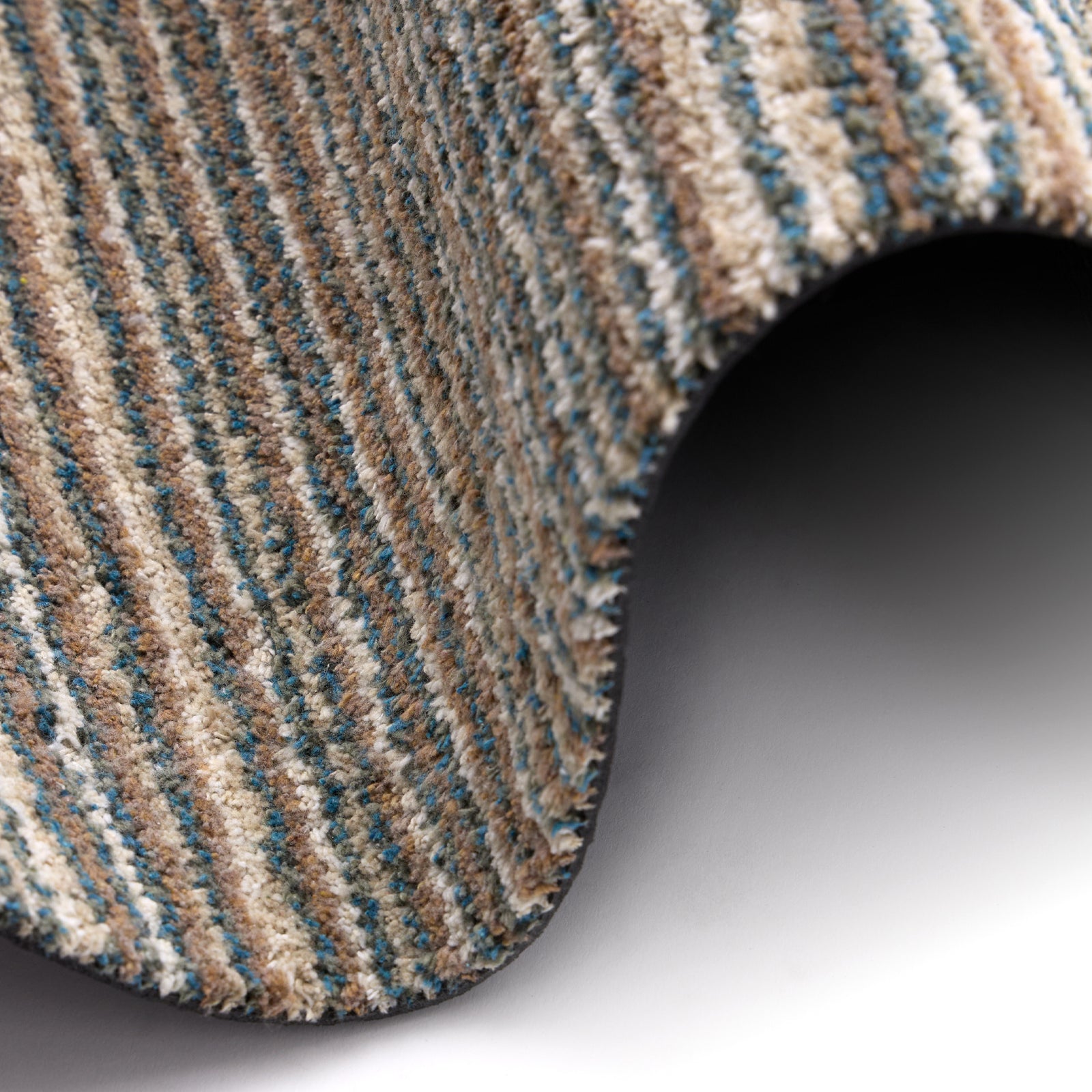 Candy Sand Stripe Washable Doormat- a recycled material doormat with a fleck design in the shades of teal, beige, brown, white, and light grey. 