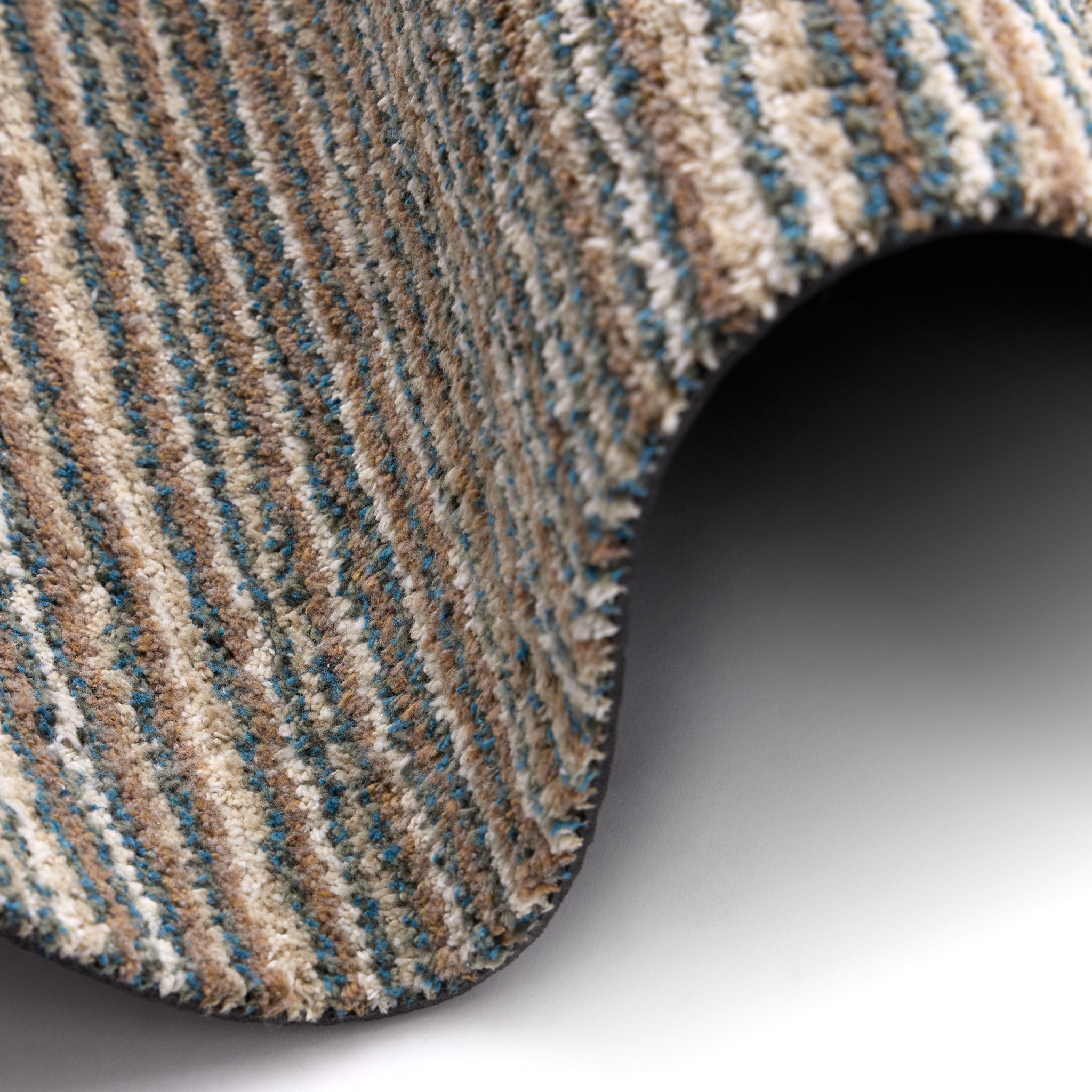 Candy Sand Stripe Washable Doormat- a recycled material doormat with a fleck design in the shades of teal, beige, brown, white, and light grey. 