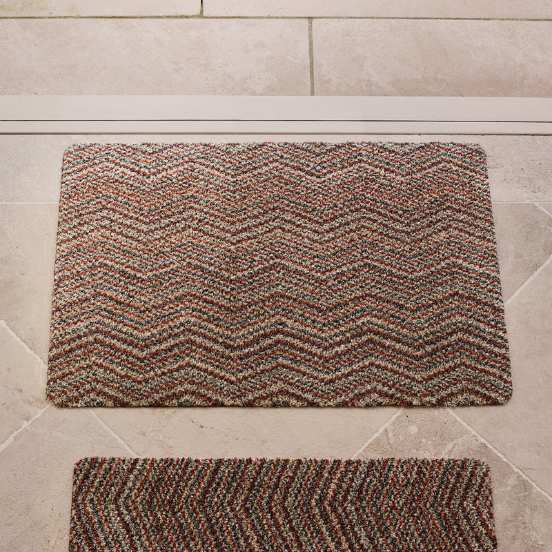 Candy Zig Zag Cotton Doormat with zig zag pattern, styled in a entryway.