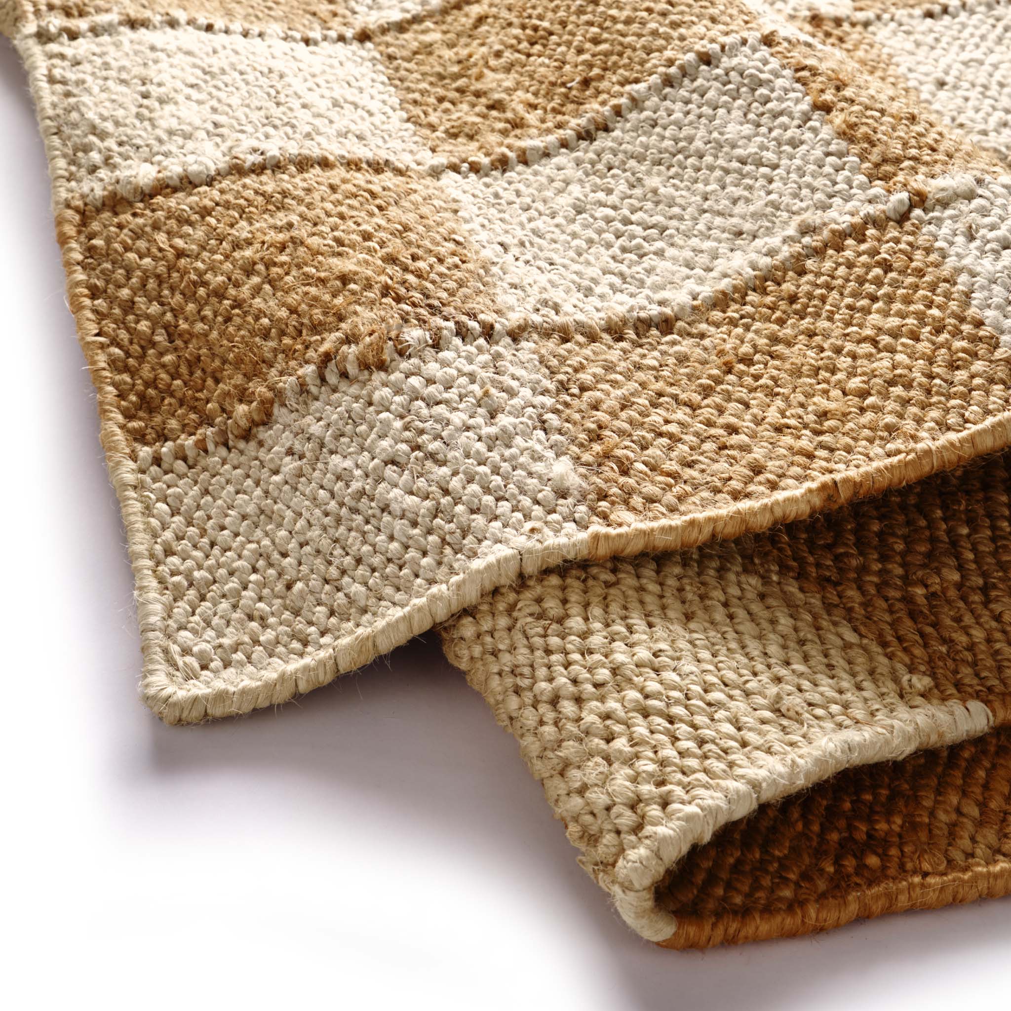 Close-up of Checkerboard Jute Natural Rug with natural and brown checkerboard pattern.